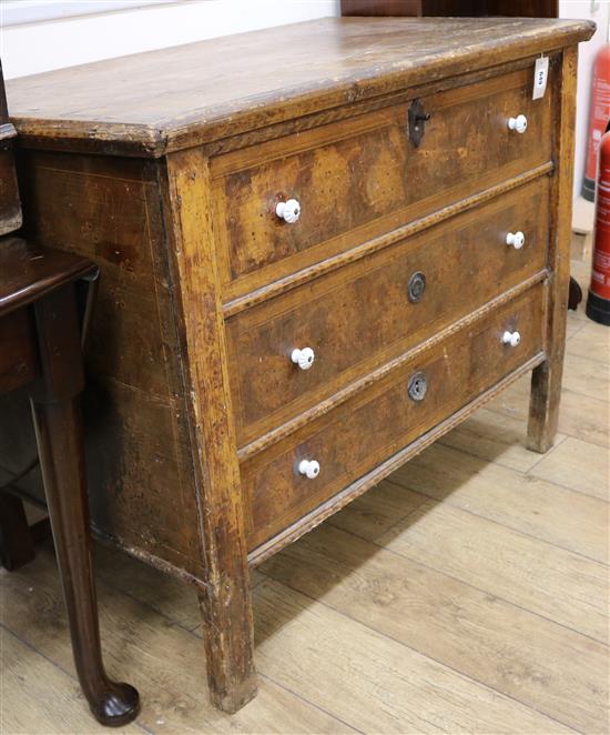 An early 19th century Continental scrumballed pine monks chest, with candle box and base drawer, W.110cm